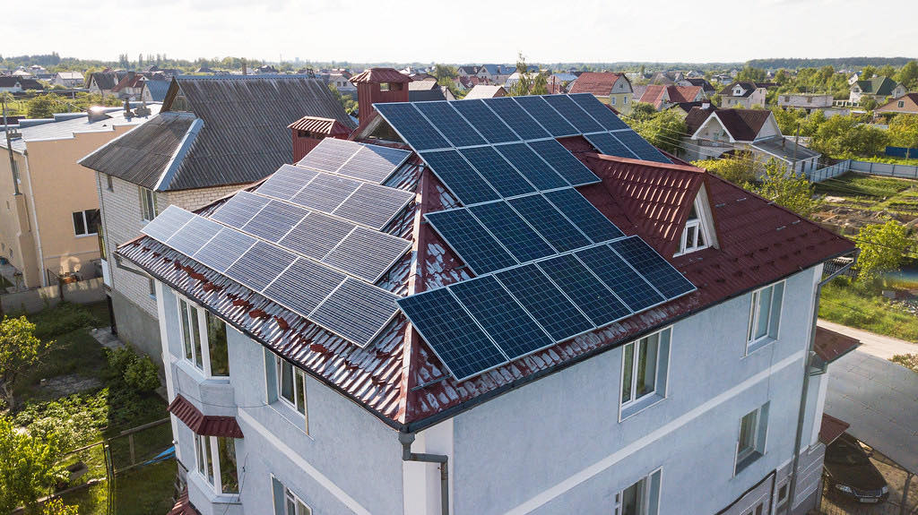 A residential roof fully fitted with solar panels (openly-licensed stand-in photo)